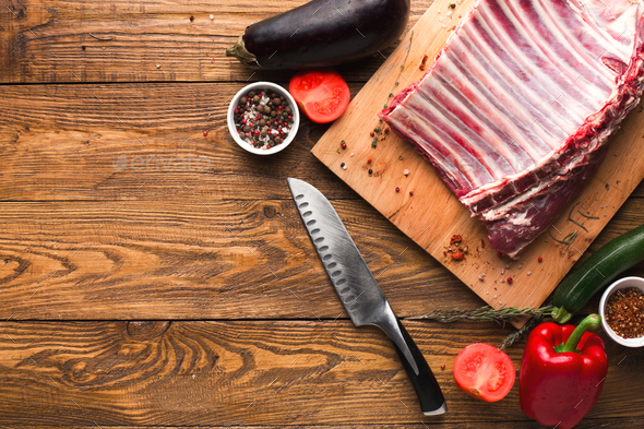 Raw rack of lamb on wooden board - Stock Photo - Images