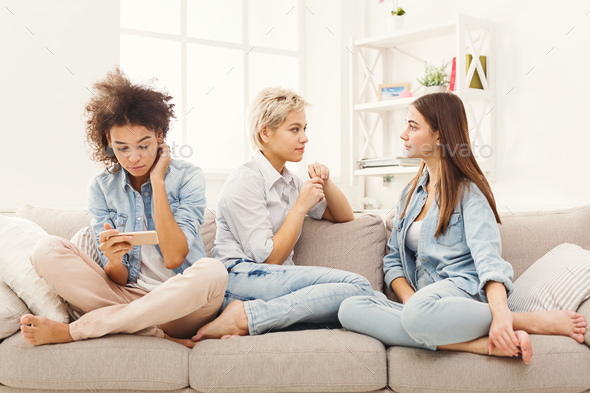 Three female friends relaxing at home - Stock Photo - Images