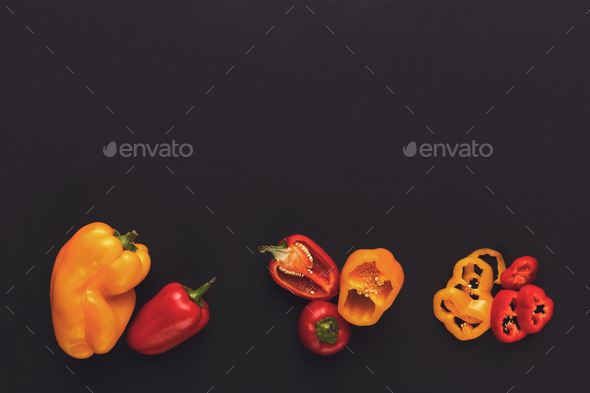 Whole and cut bell pepper on black isolated background - Stock Photo - Images