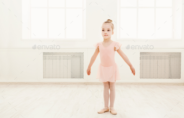 Little cute ballerina exercising in ballet costume - Stock Photo - Images