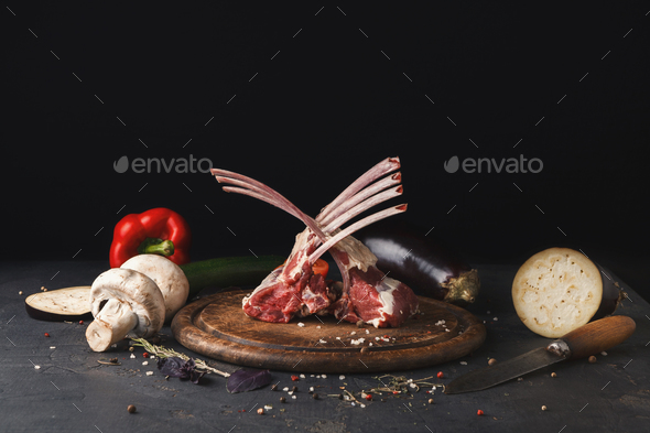 Raw cut rack of lamb on wooden board - Stock Photo - Images