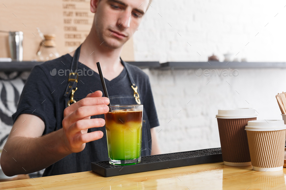 Concentrated bartender making coffee cocktail at cafe counter - Stock Photo - Images