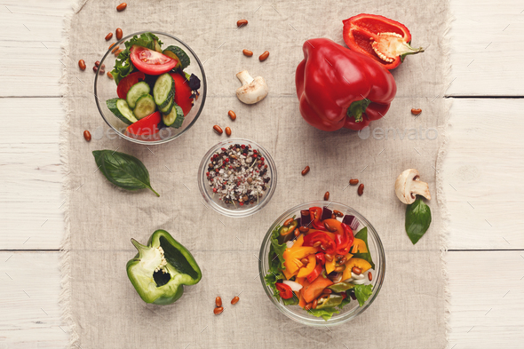 Various salad bowls on white wooden table, top view - Stock Photo - Images