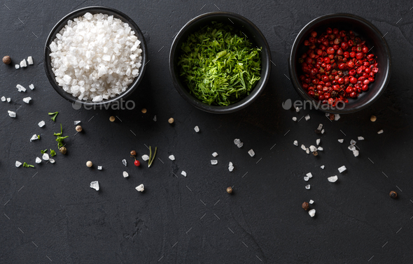 Diverse spices in plates on dark background, closeup, copy space - Stock Photo - Images