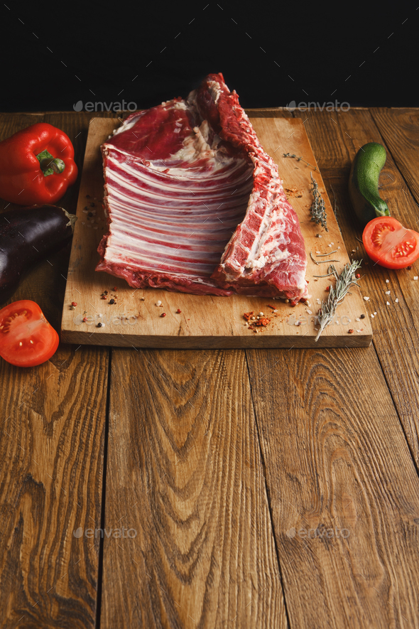 Raw rack of lamb on wooden board - Stock Photo - Images