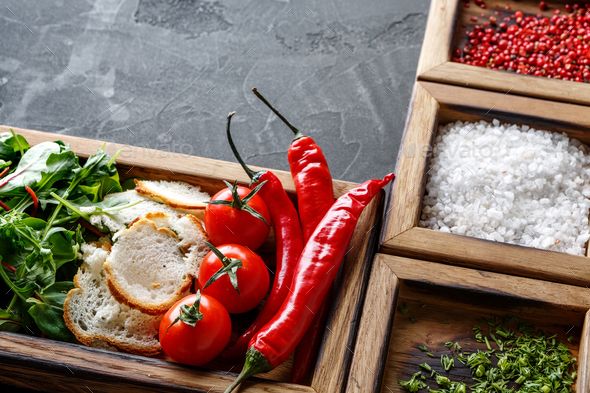 Cooking ingredients and herbs in wooden box on dark background - Stock Photo - Images