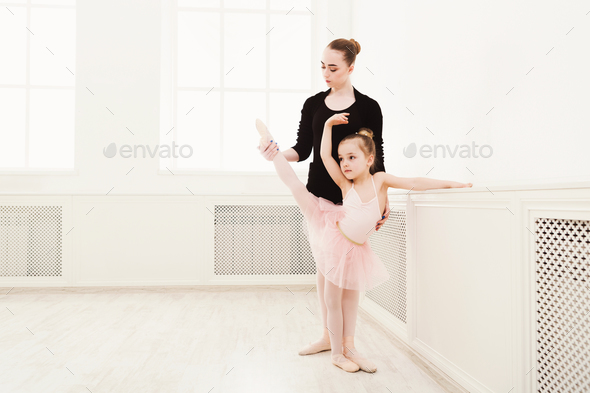 Little girl learn ballet with teacher copy space - Stock Photo - Images