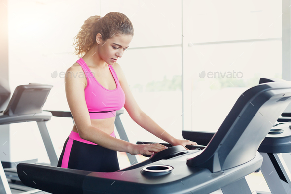 Attractive woman on treadmill in fitness club, healthy lifestyle - Stock Photo - Images