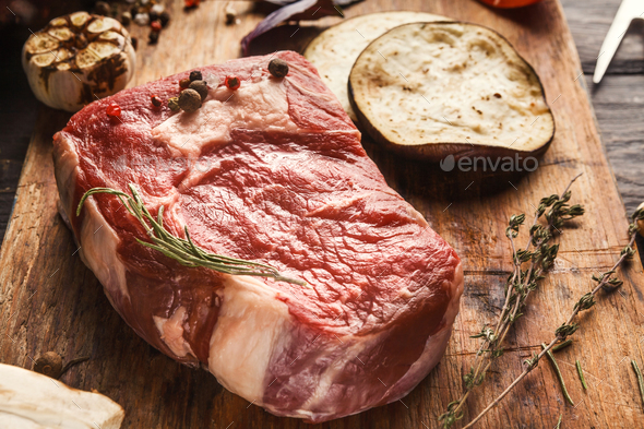 Raw beef filet mignon steaks on wooden board - Stock Photo - Images