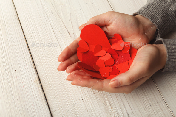 Valentine day background, hearts in female hands - Stock Photo - Images