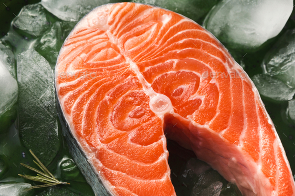 Fresh salmon with ice at dark background - Stock Photo - Images
