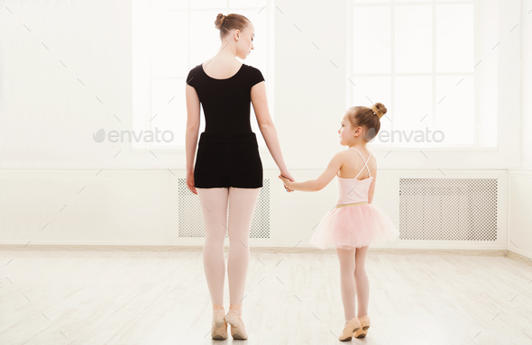 Little girl learn ballet with teacher copy space - Stock Photo - Images