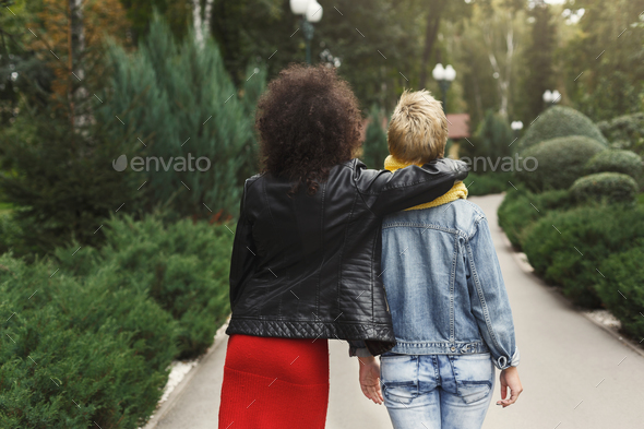 Happy girls having fun while walking in the park - Stock Photo - Images