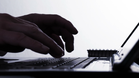 Hackers Hands Typing on Laptop Keyboard