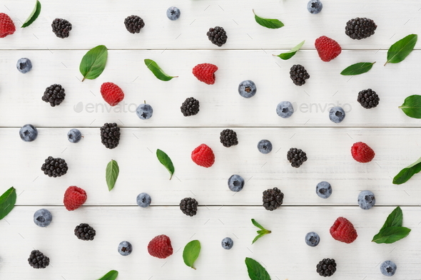 Assorted berries on white wooden table top view - Stock Photo - Images