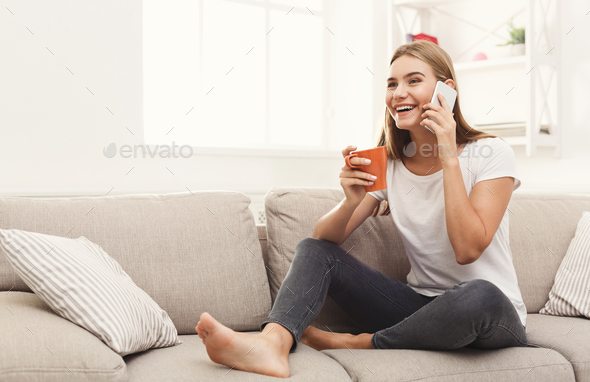 Smiling young girl calling on mobile phone - Stock Photo - Images