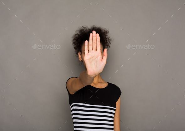 Young woman covering her face with palm - Stock Photo - Images