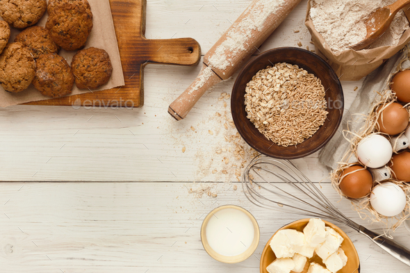 Oatmeal cookies and baking ingredients for homemade pastry background - Stock Photo - Images