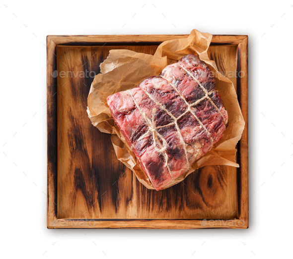 Raw aged prime black angus beef in craft paper - Stock Photo - Images