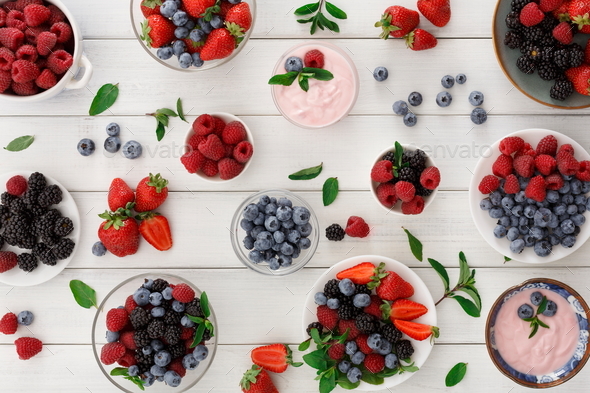 Healthy breakfast with berries and yogurt on white wooden table - Stock Photo - Images