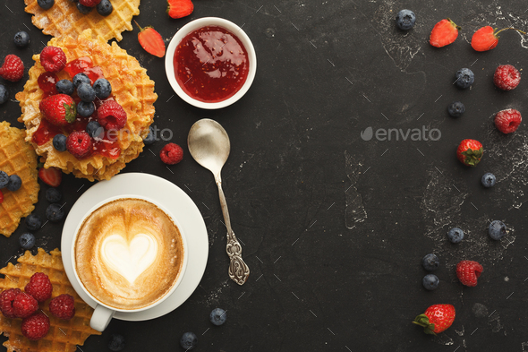 Round belgium waffles with berries, tasty breakfast on black background - Stock Photo - Images