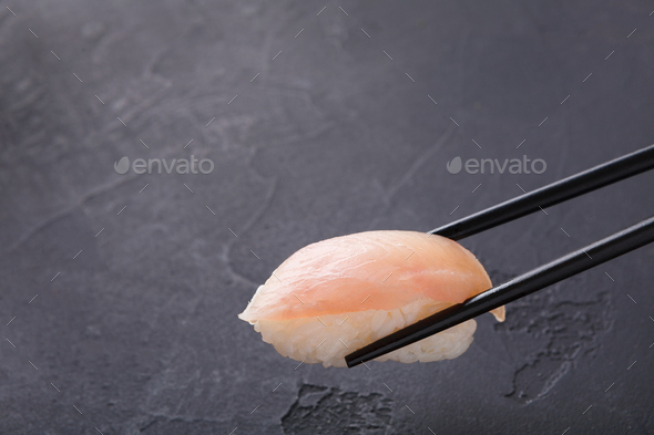 Eating sushi at restaurant, japanese cuisine - Stock Photo - Images