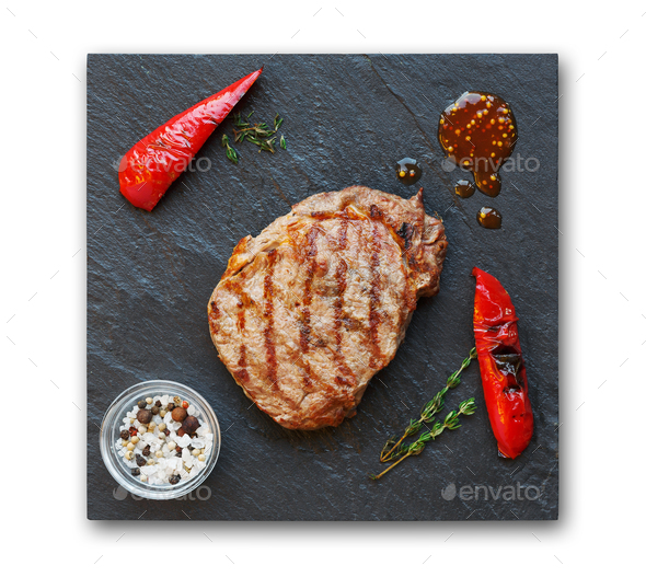 Grilled beef steak and pepprs isolated on white - Stock Photo - Images