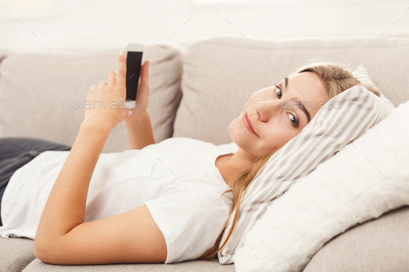 Girl at home chatting online on smartphone - Stock Photo - Images