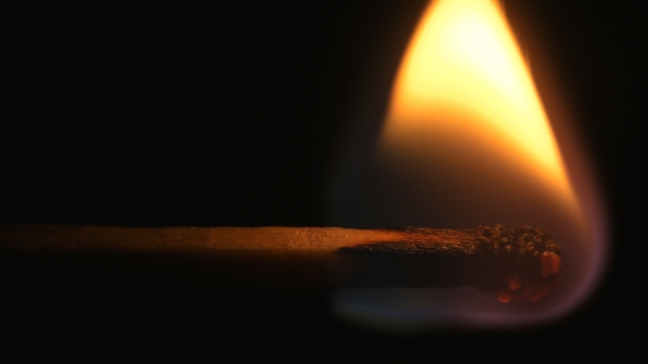 Burning Match And Flame. Safety Match  on a Black Background.