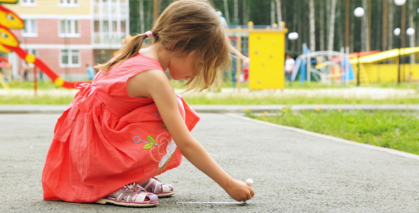 Little Girl Drawing With the Chalk