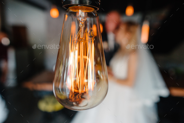 retro bulbs lights. newlyweds couple embracing - Stock Photo - Images