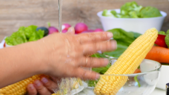 Hands Wash Corn Under the Water