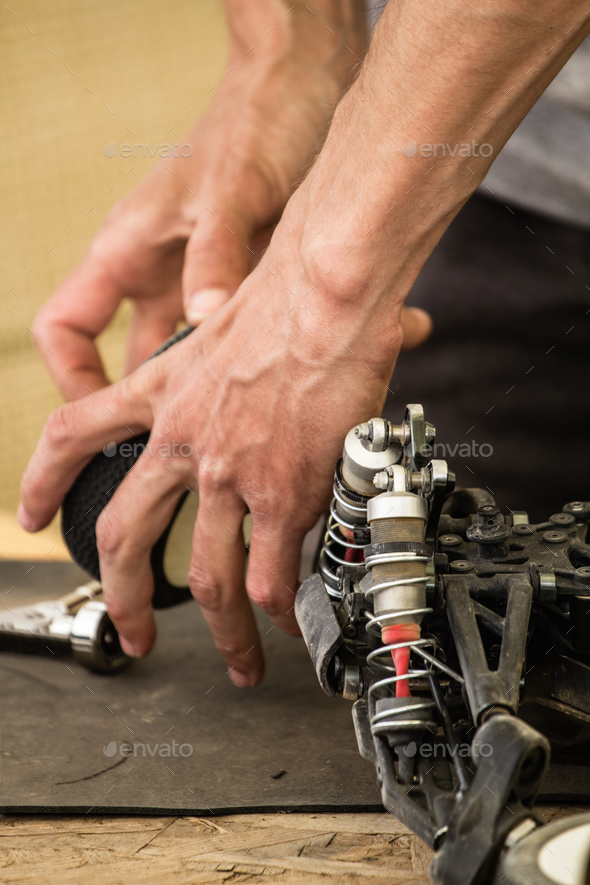 Maintenance of radio-controlled model of the car in a break betw - Stock Photo - Images