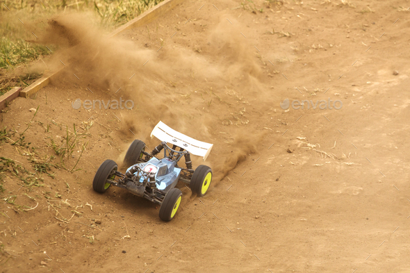 Radio controlled car model in race on dirt track - Stock Photo - Images