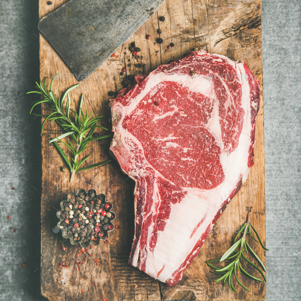 Raw prime beef meat steak rib-eye and chopping knife, flat-lay - Stock Photo - Images
