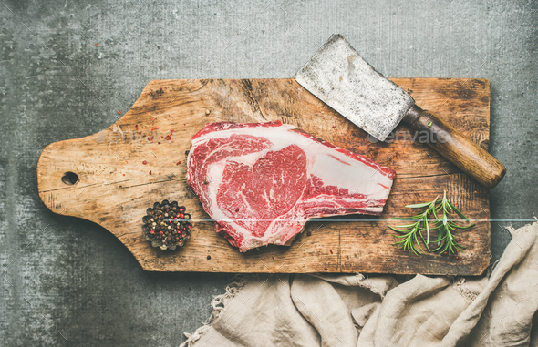 Meat dinner concept with raw uncooked beef steak rib-eye - Stock Photo - Images