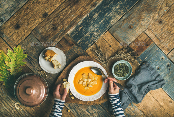 Fall warming pumpkin cream soup, copy space, top view - Stock Photo - Images