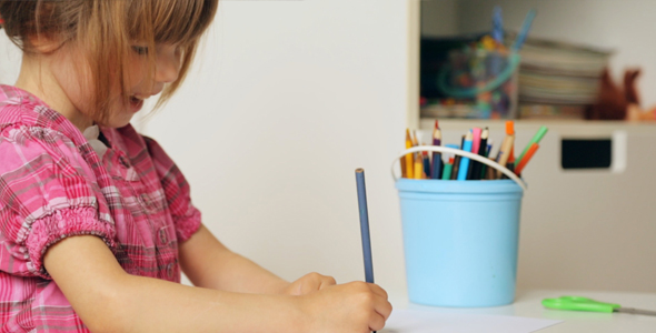 Small Girl Drawing With Colourful Pencils