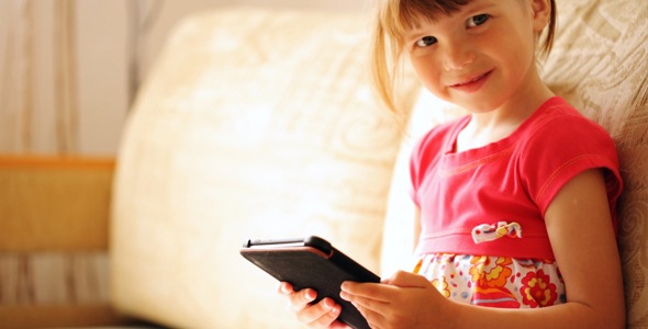 Little Girl Holding the E-book in Her Hands