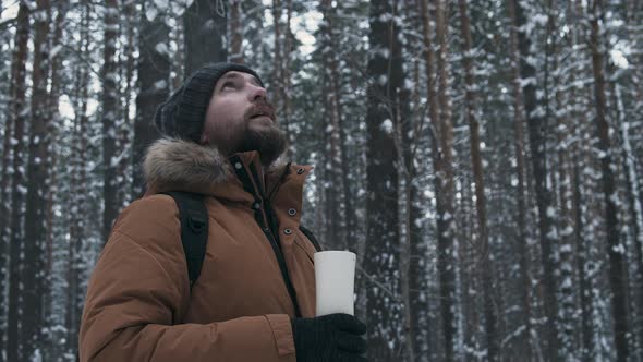 Man With Thermos In Winter Forest alt