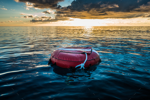 Red buoy for freediving floating in the ocean. Stock Photo by aetb