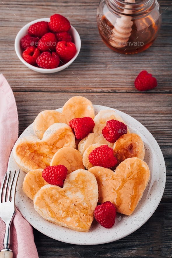 Heart shaped pancakes with raspberries and honey for St. Valentine's ...