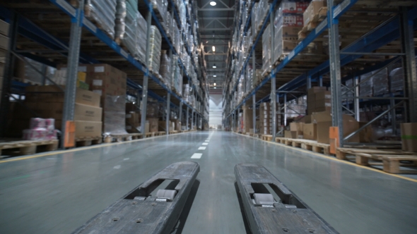 Forklift Trucks Move Between Large Metal Shelves at a Modern Warehouse alt