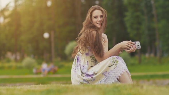 Young Beautiful Woman in Summer Dress with Long Hair Sitting on Grass ...