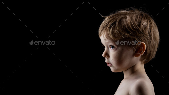 Profile portrait of four-year old boy over black Stock Photo by photobac
