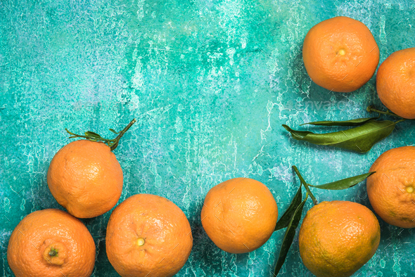 Fresh clementines over concrete slate background, food border
