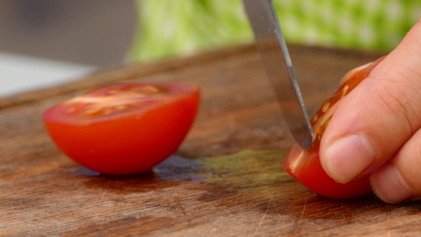 the Cook Cuts a Tomato Into Slices