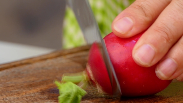 the Cook Cuts the Radish Into Slices