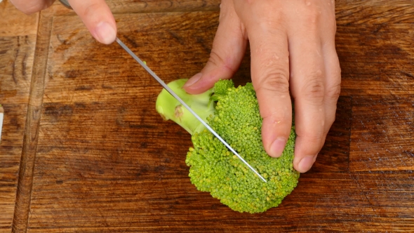 Hands To Cut Broccoli Into Slices
