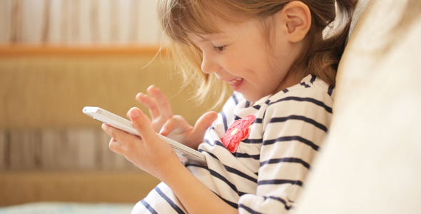 Little Girl Playing With the Smartphone